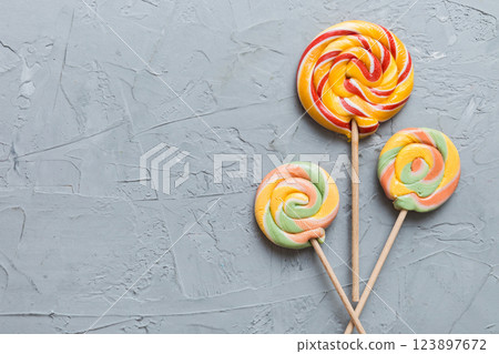 Set of colorful lollipops on colored background. Summer concept. Party Happy Birthday or Minimalist Concept Set of colorful lollipops on colored background. Summer concept. Party Happy Birthday or Minimalist Concept 123897672