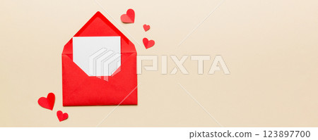 Red paper envelope with empty white card and heart on colored background. top view valentines day concept 123897700