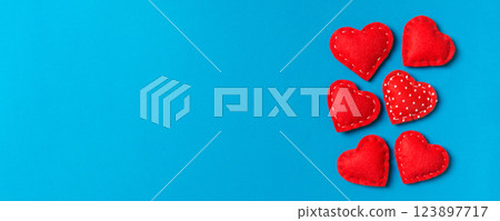 Composition of textile red hearts on colorful background with empty space for your design. Top view of St. Valentine's day concept 123897717