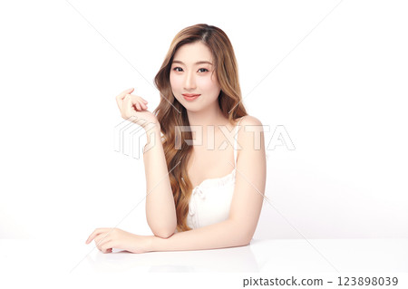A beautiful young Asian woman with clean, fresh skin against a white background. She represents beauty, skincare, and spa treatments. A beautiful young Asian woman with clean, fresh skin against a white background. She represents beauty, skincare, and spa treatments. 123898039