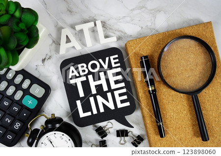 ATL - Above The Line acronym with calculator, alarm clock and magnifying glass, Business concept background ATL - Above The Line acronym with calculator, alarm clock and magnifying glass, Business concept background 123898060