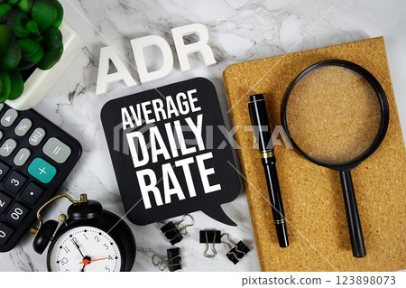 ADR Average Daily Rate acronym with calculator, alarm clock and magnifying glass, Business concept background 123898073