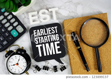 EST - Earliest Starting Time acronym with calculator, alarm clock and magnifying glass, Business concept background 123899137