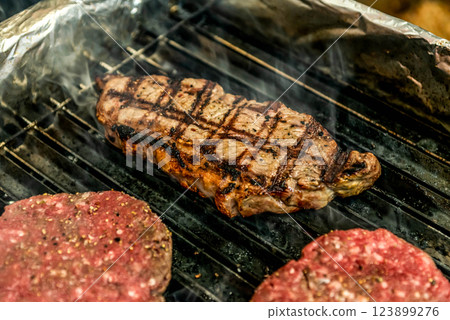 A top sirloin steak flame broiled on a barbecue shallow depth of field. A top sirloin steak flame broiled on a barbecue shallow depth of field. 123899276