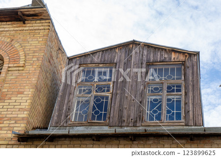 Old wooden attic above the roof of the house. Attic with windows Old wooden attic above the roof of the house. Attic with windows 123899625