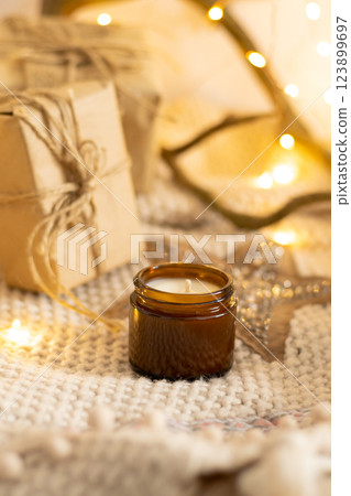 Soy aroma candle in beige background. Candle in a glass jar. 123899697
