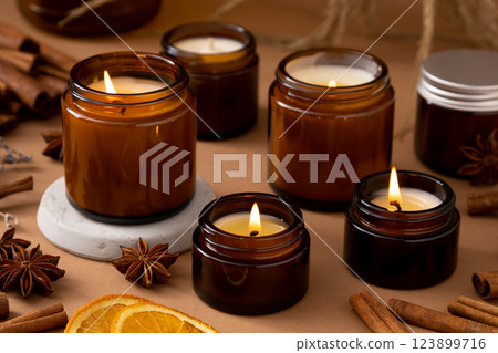 A set of different aroma candles in glass jars on a white background. Scented handmade candle. Soy candles are burning in a jar.Wax and paraffin in a jar A set of different aroma candles in glass jars on a white background. Scented handmade candle. Soy candles are burning in a jar.Wax and paraffin in a jar 123899716