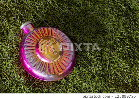 Old glass Christmas tree toy in the shape of a sun. Old glass Christmas tree toy in the shape of a sun. 123899750