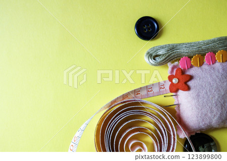 Sewing kit and yellow background 123899800