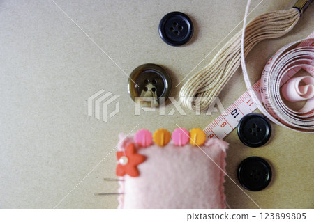 Sewing supplies and gray background Sewing supplies and gray background 123899805