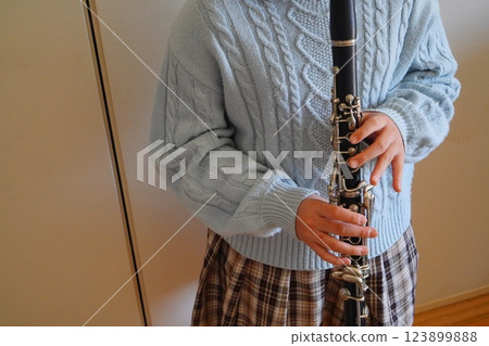 A fifth grade elementary school student who has been playing the clarinet for 1 year and 11 months practices the clarinet. A fifth grade elementary school student who has been playing the clarinet for 1 year and 11 months practices the clarinet. 123899888