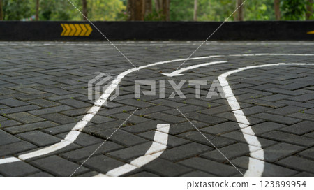 Curved path on brick pavement with directional arrows for guidance Curved path on brick pavement with directional arrows for guidance 123899954