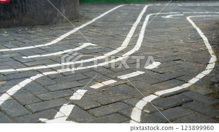 Playground pavement with painted road lines and arrows for children play 123899960