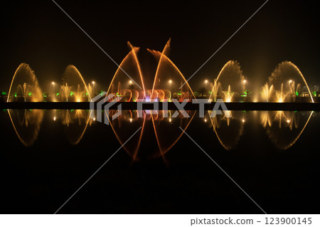 Reflection of the night light show on the water. 123900145