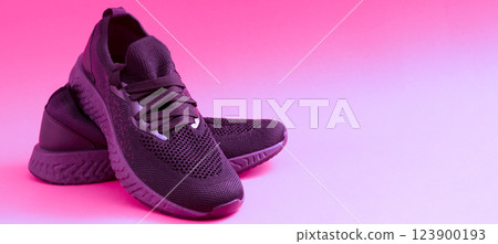 Sneakers concept with place for text. Close-up of pink sneakers on a bright background. Sports shoes for running and fitness. A comfortable everyday pair of shoes. Sneakers concept with place for text. Close-up of pink sneakers on a bright background. Sports shoes for running and fitness. A comfortable everyday pair of shoes. 123900193