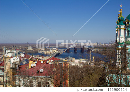 Panorama of the city of Kyiv from a height. View from above on the roofs of Podil. Houses, residential area architecture. Ukrainian capital. Aerial top view of Kyiv skyline 123900324
