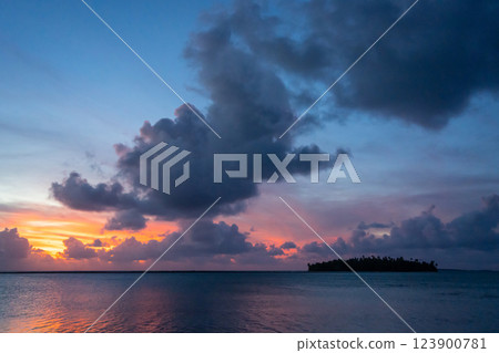Sunset over a tropical motu on Tikehau Atoll, French Polynesia Sunset over a tropical motu on Tikehau Atoll, French Polynesia 123900781