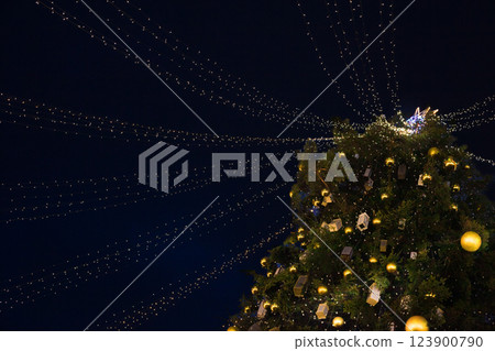 Street city Christmas tree at night. The garlands are burning. Holiday decorations and toys. Garland of lights. Street city Christmas tree at night. The garlands are burning. Holiday decorations and toys. Garland of lights. 123900790