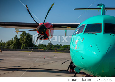 Airplane medium-range turboprop passenger aircraft. Plane at the Airport. Cockpit close up. Runway. Propeller. Turbine engine. Airplane medium-range turboprop passenger aircraft. Plane at the Airport. Cockpit close up. Runway. Propeller. Turbine engine. 123900820