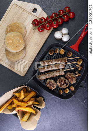 grilled meat and shasliks with mushrooms and tomatos served with french fries 123901761