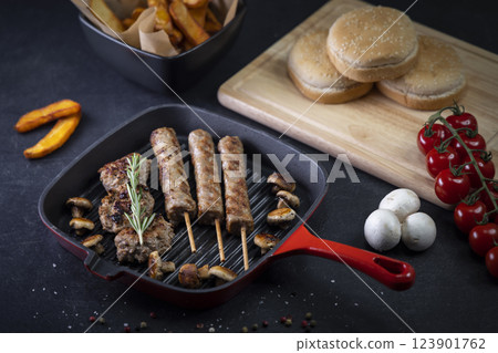 grilled meat and shasliks with mushrooms and tomatos served with french fries grilled meat and shasliks with mushrooms and tomatos served with french fries 123901762