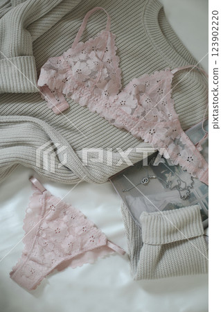 Woman's silk erotic lingerie on the white bed sheets. Valentine's day concept. Lace sexy female underwear. Beauty, fashion blogger concept. Female bra, panties, erotic clothes. Lingerie advertising 123902220