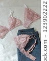 Woman's silk erotic lingerie on the white bed sheets. Valentine's day concept. Lace sexy female underwear. Beauty, fashion blogger concept. Female bra, panties, erotic clothes. Lingerie advertising 123902222