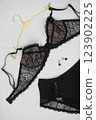 Woman's silk erotic lingerie on the white bed sheets. Valentine's day concept. Lace sexy female underwear. Beauty, fashion blogger concept. Female bra, panties, erotic clothes. Lingerie advertising 123902225