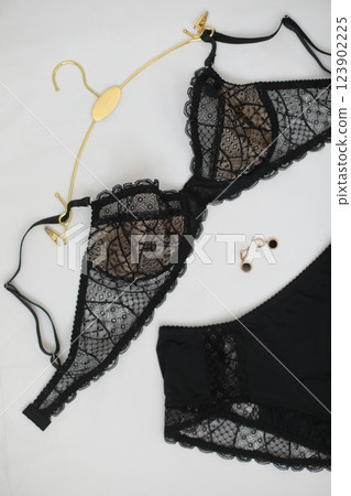 Woman's silk erotic lingerie on the white bed sheets. Valentine's day concept. Lace sexy female underwear. Beauty, fashion blogger concept. Female bra, panties, erotic clothes. Lingerie advertising Woman's silk erotic lingerie on the white bed sheets. Valentine's day concept. Lace sexy female underwear. Beauty, fashion blogger concept. Female bra, panties, erotic clothes. Lingerie advertising 123902225