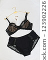 Woman's silk erotic lingerie on the white bed sheets. Valentine's day concept. Lace sexy female underwear. Beauty, fashion blogger concept. Female bra, panties, erotic clothes. Lingerie advertising 123902226