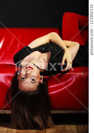 Fashion woman in red pantyhose on couch Fashion woman in red pantyhose on couch 123902310