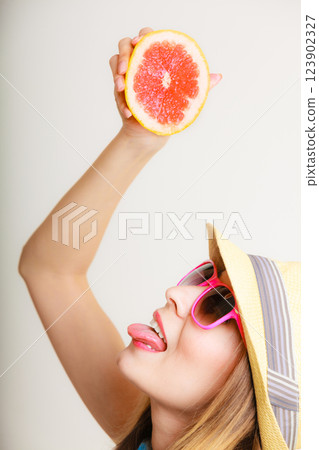 Summer girl tourist holding grapefruit citrus fruit 123902327