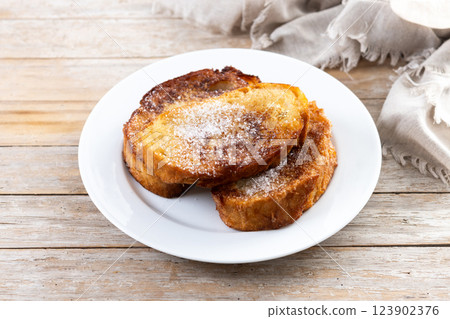 Traditional Spanish torrijas for Holy Week on wooden table. French Toast Traditional Spanish torrijas for Holy Week on wooden table. French Toast 123902376