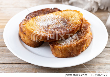 Traditional Spanish torrijas for Holy Week on wooden table. French Toast Traditional Spanish torrijas for Holy Week on wooden table. French Toast 123902377