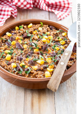 Traditional Mexican Chili con carne. Minced meat and vegetables stew in tomato sauce on wooden table 123902380