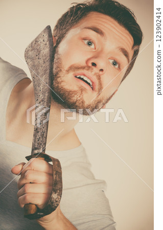 Young man shaving having fun with machete. Young man shaving having fun with machete. 123902414