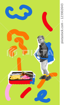 Boy with backpack looking back at open suitcase filled with travel essentials, set against abstract background. 123902643