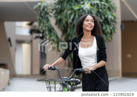 Healthy Living and Sustainable Choices. A woman cycling with a radiant smile, embracing an eco-conscious lifestyle. 123902829