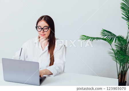 woman working at desk with laptop in online office training 123903070