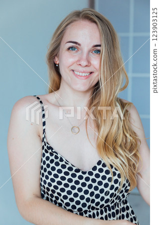 Beautiful fashion blonde woman smiling in summer light dress 123903125