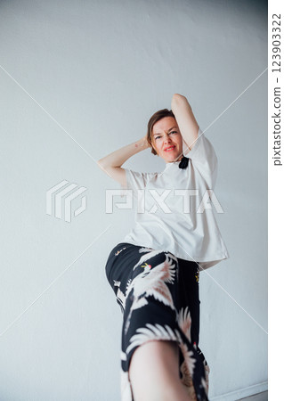 Beautiful woman of 40 years old in a fashionable suit on a white background Beautiful woman of 40 years old in a fashionable suit on a white background 123903322