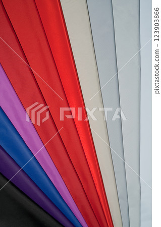 Vibrant fabric strips in red, purple, blue, and gray. 123903866