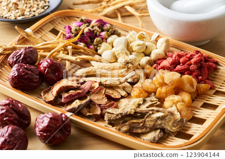 Chinese herbal medicine ingredients served in a colander 123904144