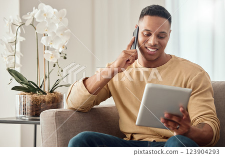 Phone call, young man and digital planning schedule on tablet or online shopping on living room sofa. Happy male, listen to good news or tech customer service online support communication at home Phone call, young man and digital planning schedule on tablet or online shopping on living room sofa. Happy male, listen to good news or tech customer service online support communication at home 123904293