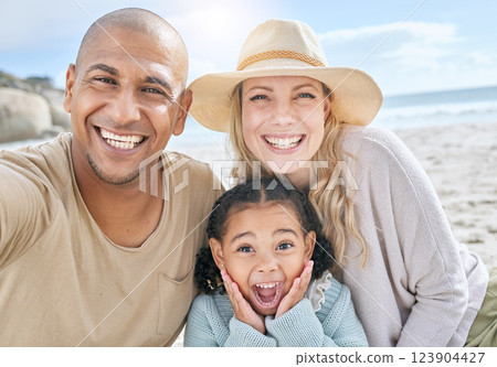 Selfie, beach and portrait of a happy family on vacation together in nature by the ocean. Happy, smile and parents with their girl child taking photo while relaxing at seaside on holiday or adventure 123904427