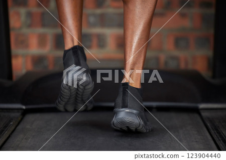 Runner, feet and shoes on treadmill in gym workout, training and workout for heart cardio health, wellness and energy. Zoom, black man and sports marathon athlete running in fitness practice for race 123904440