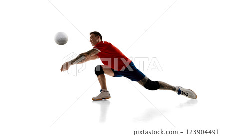 Dynamic image of professional volleyball player, male athlete in motion during game, training against white studio background 123904491