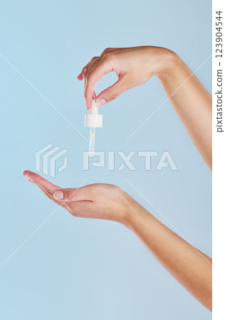 Skincare serum, essential oil and woman hand cosmetic product for perfect, smooth skin or reduce wrinkles isolated on studio background. Zoom in of hands using body care or anti aging liquid drop 123904544