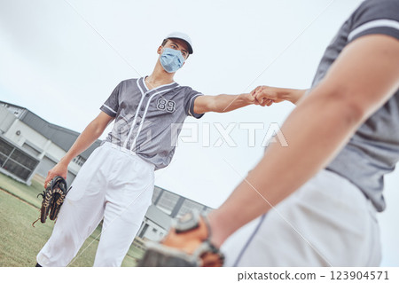 Sports baseball, covid and teamwork fist bump for match game collaboration, competition partnership or support trust. Softball fitness training, exercise workout or man with winner mindset motivation Sports baseball, covid and teamwork fist bump for match game collaboration, competition partnership or support trust. Softball fitness training, exercise workout or man with winner mindset motivation 123904571