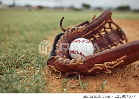 Baseball, ball and glove on an outdoor pitch for sport training, fitness or a tournament game. Exercise, sports equipment and softball match on a professional field or stadium with grass and sand. Baseball, ball and glove on an outdoor pitch for sport training, fitness or a tournament game. Exercise, sports equipment and softball match on a professional field or stadium with grass and sand. 123904577
